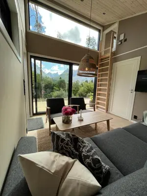 a living room with a couch and a table at Kavliskogen panorama in Isfjorden