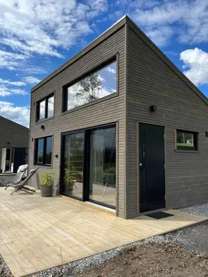 a house with large windows and a wooden deck at Kavliskogen panorama in Isfjorden