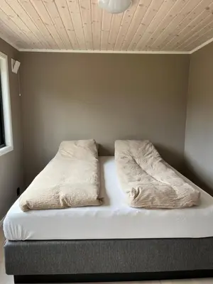 a bed with two pillows on top of it at Kavliskogen panorama in Isfjorden