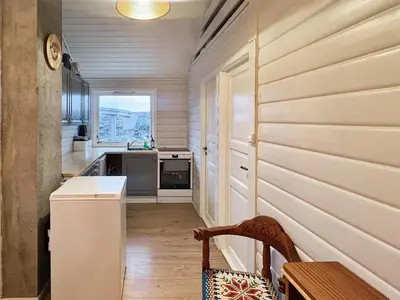 a kitchen with a table and a chair in a room at 6 person holiday home in bremnes-By Traum in Bremnes
