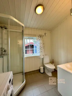 a bathroom with a shower and a toilet and a sink at Large cabin Sjusjøen XC ski in out & lovely view in Ringsaker