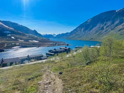 a view of a lake with mountains in the background at Gjendesheim Turisthytte in Besseggen