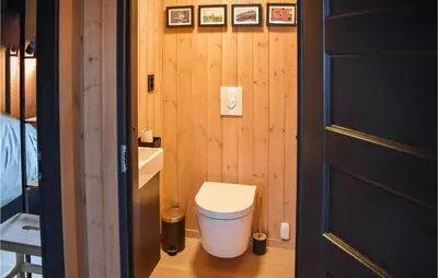 a small bathroom with a toilet and a sink at Cozy Home In Rauland With Sauna in Torvetjørn