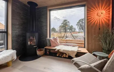 a living room with a fireplace and a window at Cozy Home In Rauland With Sauna in Torvetjørn