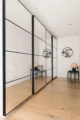 a room with glass walls and a table and chairs at Dinbnb Apartments I Luxury with Views l Large Balcony in Bergen