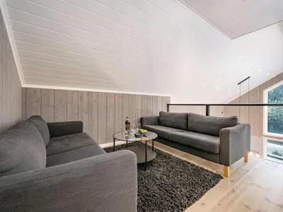 a living room with two couches and a table at Holiday Home Mathias by Interhome in Vik