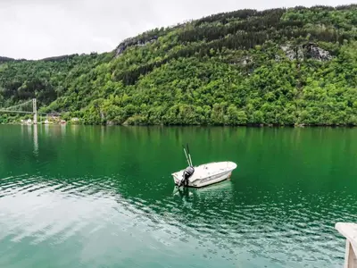 a boat sitting in the middle of a lake at Holiday Home Ørviksnes by Interhome in Steinstø