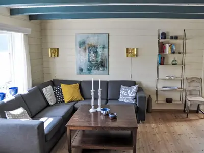 a living room with a couch and a table at Holiday Home Ørviksnes by Interhome in Steinstø