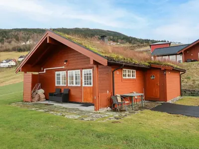 a small house with a grass roof with a table at Chalet Hagehytta by Interhome in Utvik