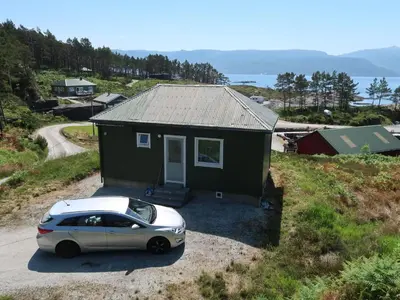a car parked in front of a small house at Holiday Home Sognesjö by Interhome in Bø