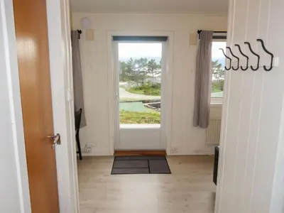 a hallway with a door leading to a window at Holiday Home Sognesjö by Interhome in Bø