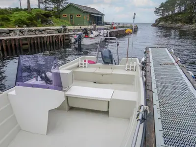 a boat is docked at a dock in the water at Holiday Home Sognesjö by Interhome in Bø