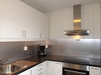 a kitchen with white cabinets and a sink at Holiday Home Sognesjö by Interhome in Bø
