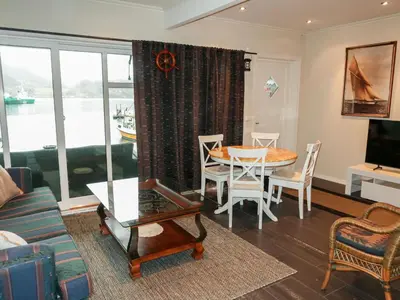 a living room with a table and a dining room at Apartment Heningen by Interhome in Uggdal