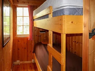 a bedroom with a bunk bed in a cabin at Chalet Trefall by Interhome in Gausvik