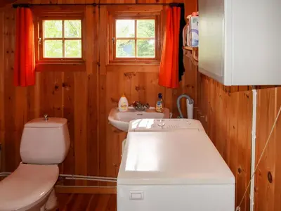 a bathroom with a toilet and a sink at Chalet Trefall by Interhome in Gausvik