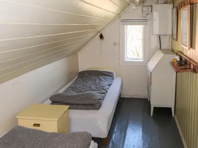 a small room with two beds and a window at Holiday Home Sjøhytta by Interhome in Bekkjarvik
