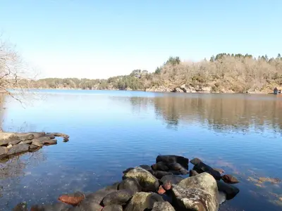 a large lake with rocks in the water at Holiday Home Sjøhytta by Interhome in Bekkjarvik