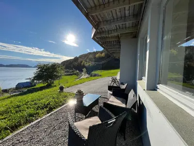 a porch with chairs and a view of the water at Apartment Bakkafall by Interhome in Svortevik