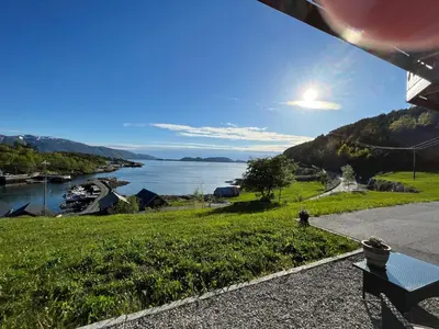 a view of the water from a house with a bench at Apartment Bakkafall by Interhome in Svortevik