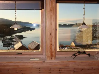 a window in a cabin with a view of a lake at Apartment Bakkafall by Interhome in Svortevik