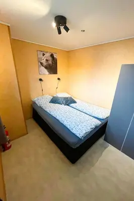 a bedroom with a bed with a dog on it at Apartment Bakkafall by Interhome in Svortevik