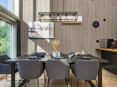 a dining room with a black table and chairs at Holiday Home Kaja by Interhome in Vik