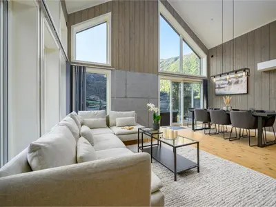 a living room with a white couch and a table at Holiday Home Kaja by Interhome in Vik