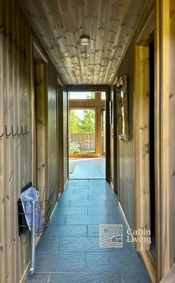 a hallway of a house with a hallway leading to a door at Sjusjøen ski in out, ski storage, Wifi, grill & fireplace, modern apartment! in Sjusjøen