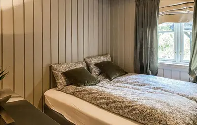 a bed with two pillows on it in a bedroom at Nice Home In Sykkylven With Kitchen in Sykkylven