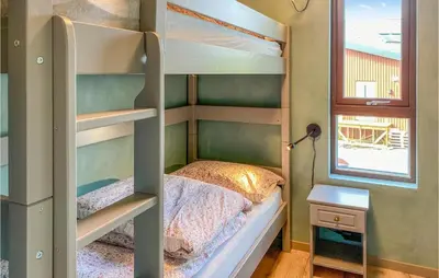 a bunk bed in a room with a window at Nice Home In Straumgjerde in Riksem