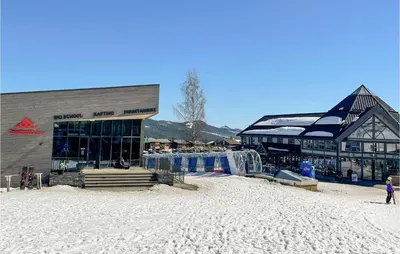 a building on a beach with snow on the ground at Pet Friendly Home In Trysil With Wifi in Trysil
