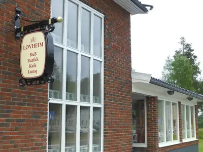 a sign on the side of a brick building at Løvheim Gjestehus in Sauland