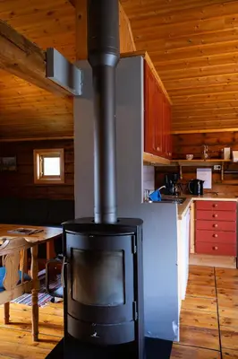 a stove in a kitchen with a wooden ceiling at Skanckegårdene AS in Røros