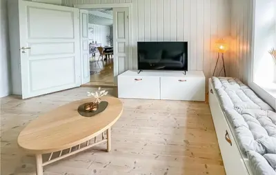 a living room with a couch and a table at Lovely Home In Koppang With Kitchen in Koppang