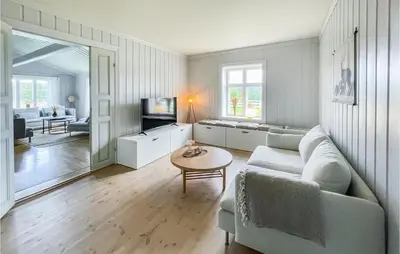 a living room with a couch and a table at Lovely Home In Koppang With Kitchen in Koppang