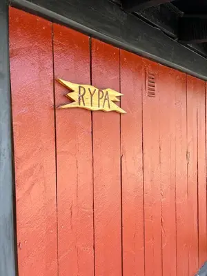 a red door with a rypa sign on it at Atnasjø Kafe AS in Sollia