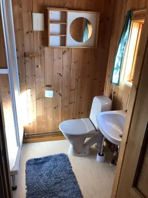 a bathroom with a toilet and a sink at Atnasjø Kafe AS in Sollia
