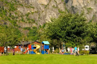 a group of people in a park with a playground at Sæbø Camping in Eidfjord