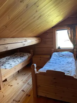 two bunk beds in a log cabin with a window at Solsetra - Mountain Majesty Family Log Cabin in Hovden