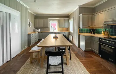 a kitchen with a wooden table and chairs in it at Gorgeous Home In Koppang With Sauna in Koppang