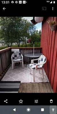 a picture of a patio with two chairs and a table at Nardo-Trondheim in Trondheim