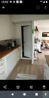 a kitchen with white cabinets and a white refrigerator at Nardo-Trondheim in Trondheim