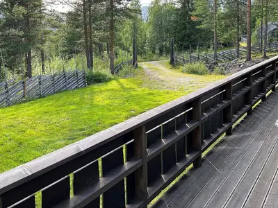a bridge with a green field on the side of it at 5 star holiday home in Hemsedal-By Traum in Hemsedal