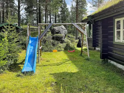 a playground with a slide in a yard at 5 star holiday home in Hemsedal-By Traum in Hemsedal