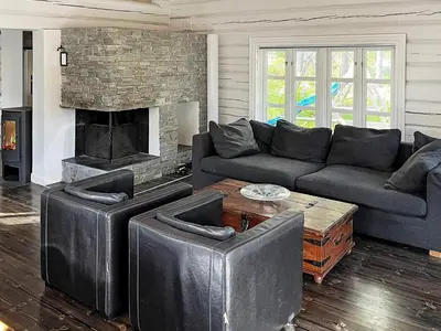 a living room with a couch and a fireplace at 5 star holiday home in Hemsedal-By Traum in Hemsedal
