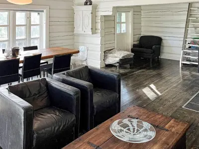 a living room with leather furniture and a wooden table at 5 star holiday home in Hemsedal-By Traum in Hemsedal