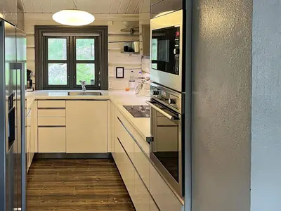 a kitchen with white cabinets and stainless steel appliances at 5 star holiday home in Hemsedal-By Traum in Hemsedal