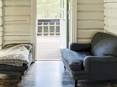 a living room with a couch and a chair at 5 star holiday home in Hemsedal-By Traum in Hemsedal