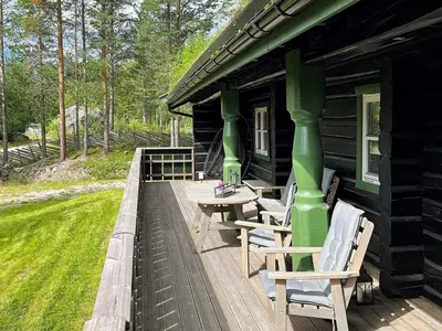 a wooden deck with chairs and a table on a cabin at 5 star holiday home in Hemsedal-By Traum in Hemsedal